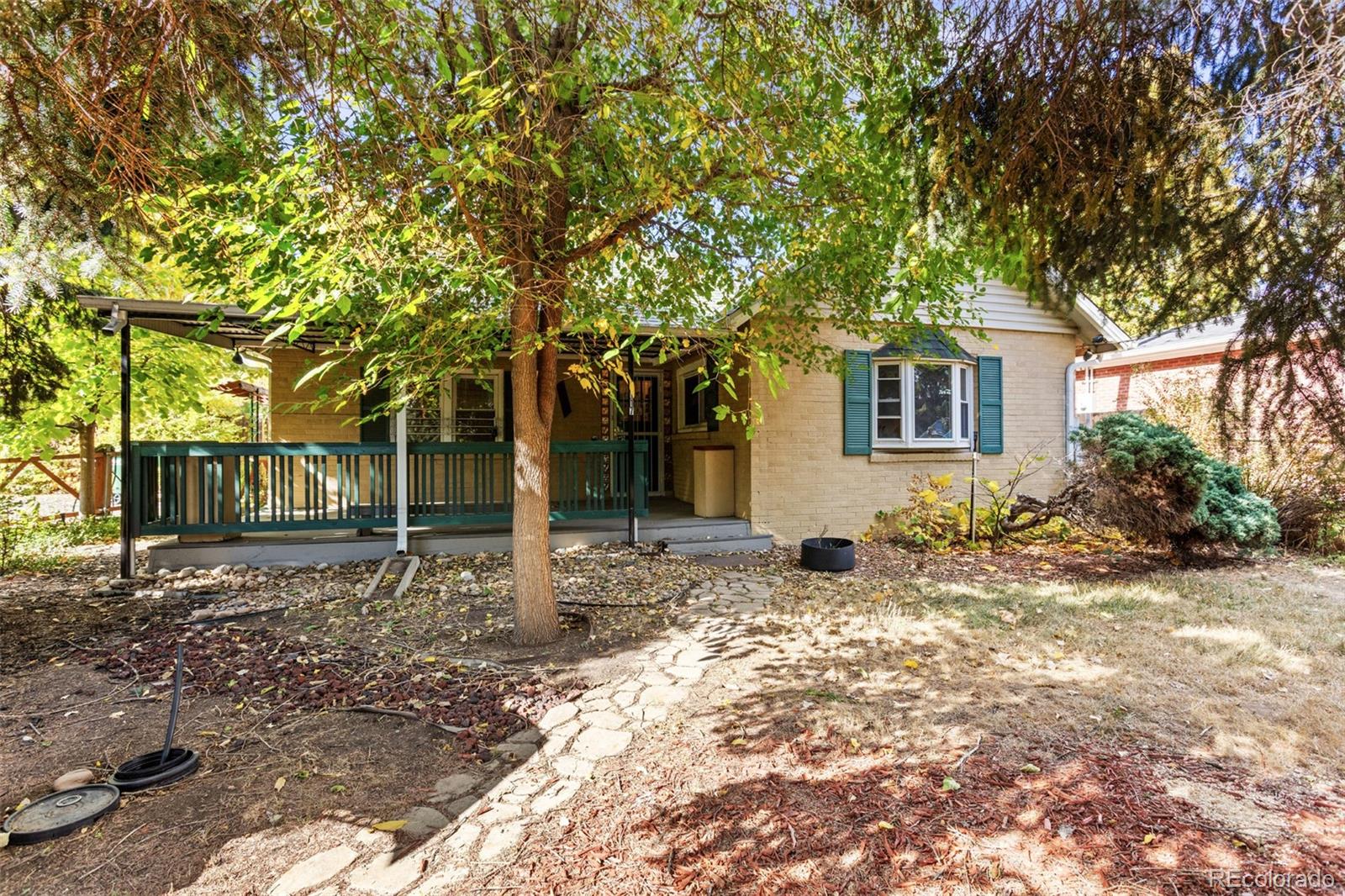 a front view of a house with a tree