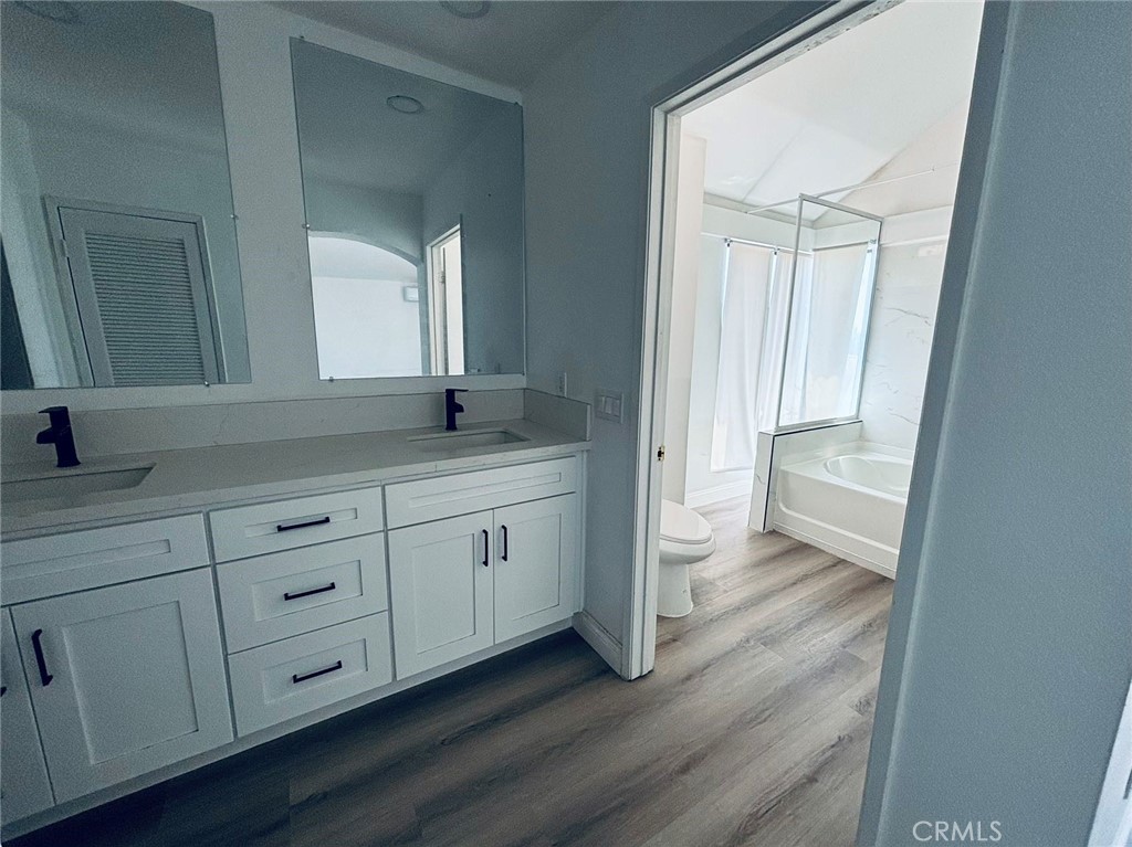 a spacious bathroom with a granite countertop sink and a mirror