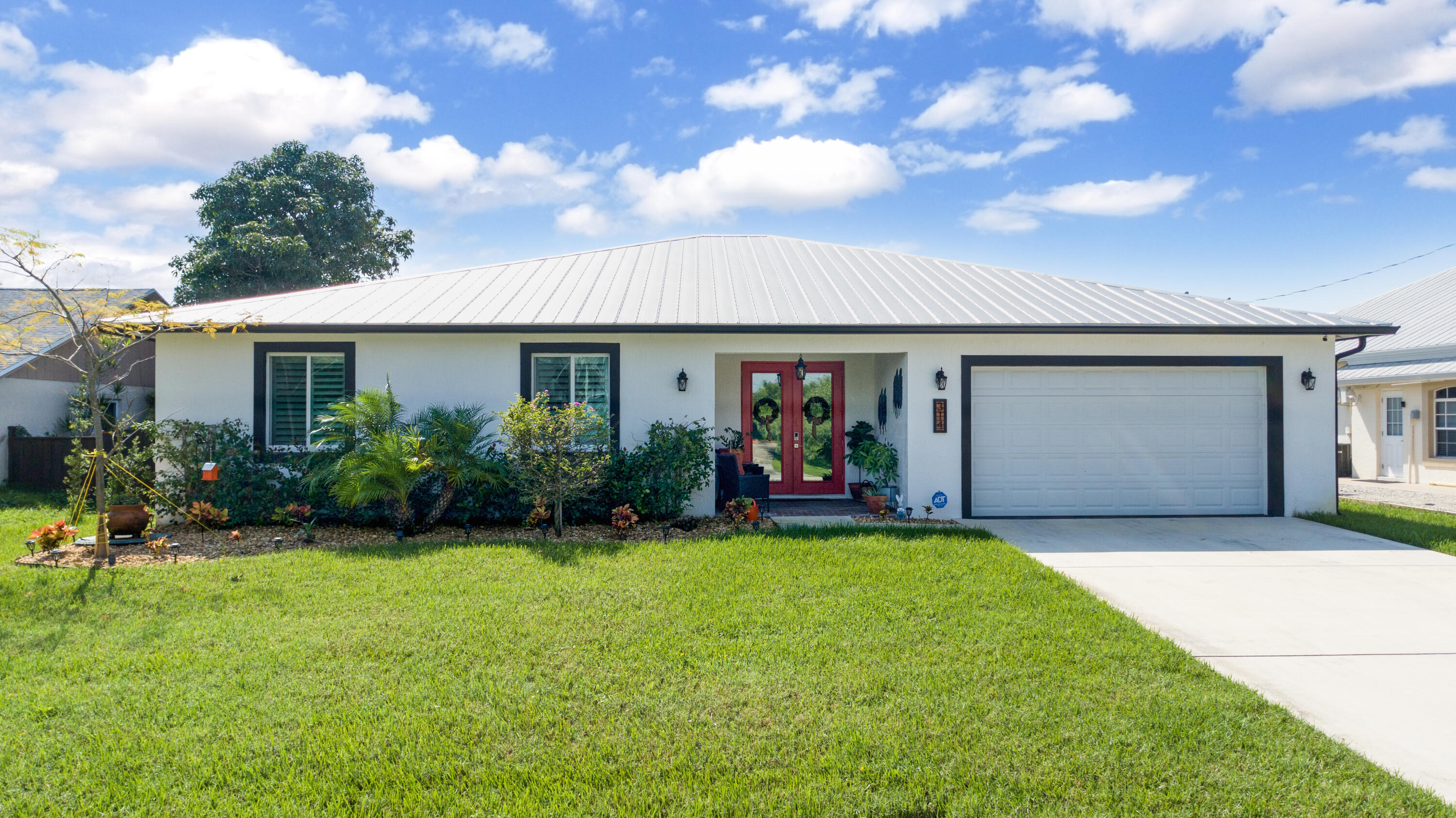 a view of a house with backyard porch and sitting area