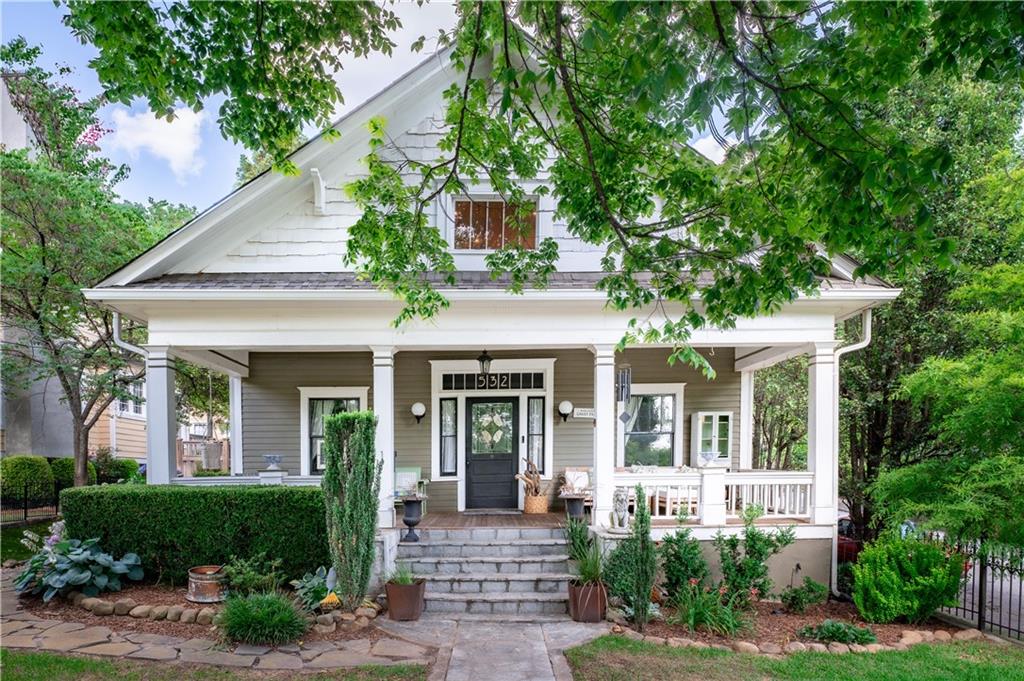 a front view of a house with porch and garden