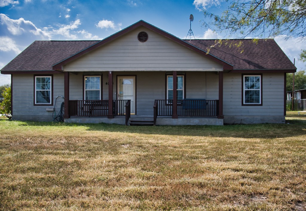 a front view of a house with a garden