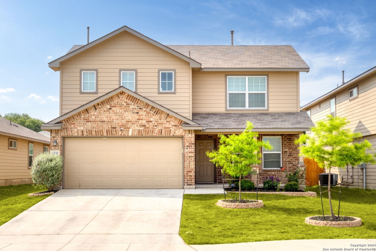 a front view of a house with garden