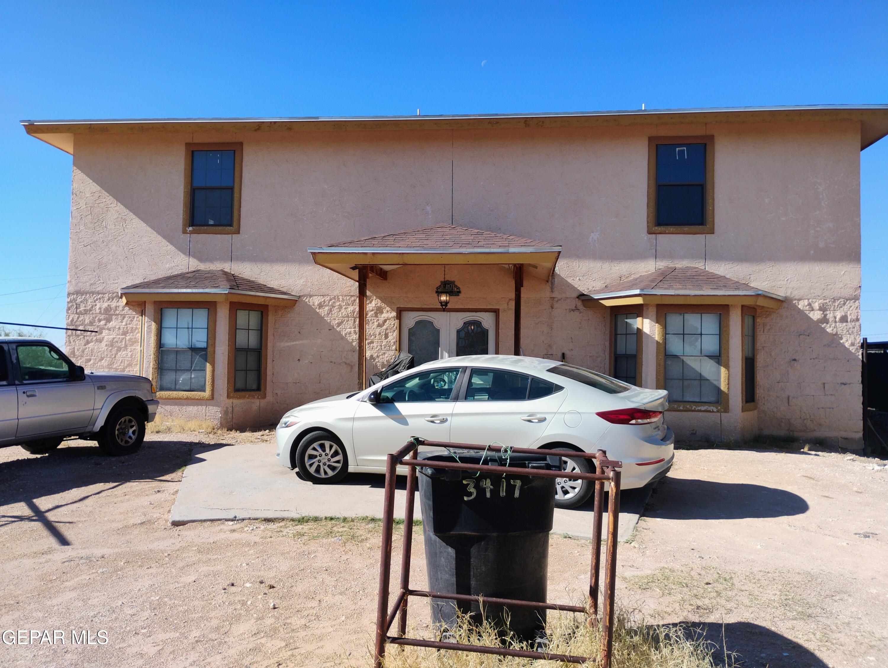 a front view of a house with parking area