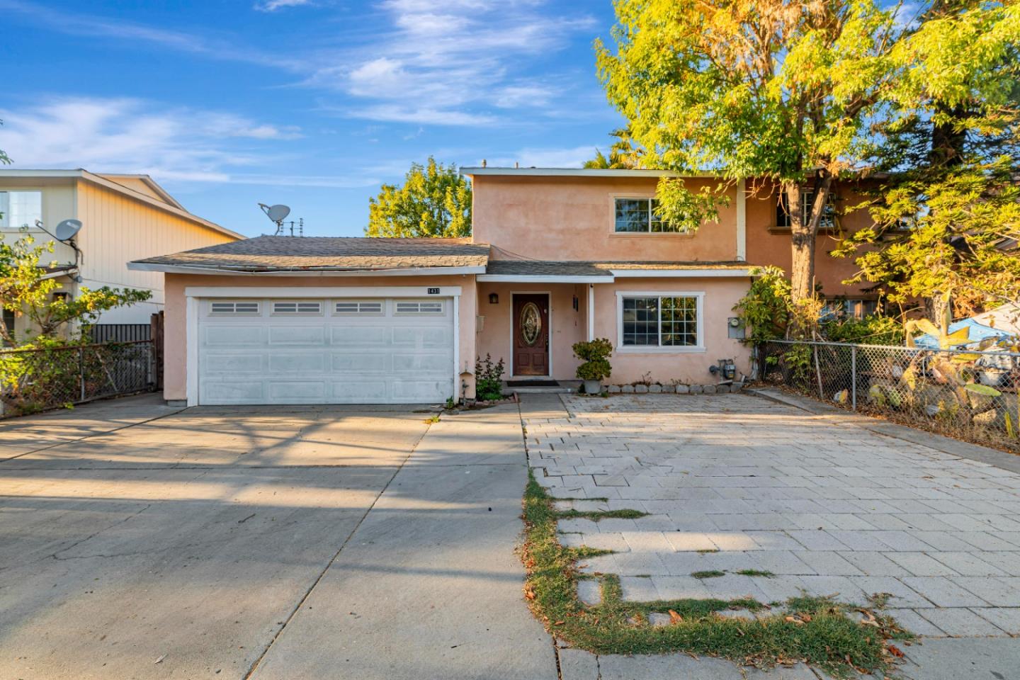 a front view of a house with a yard and a garage