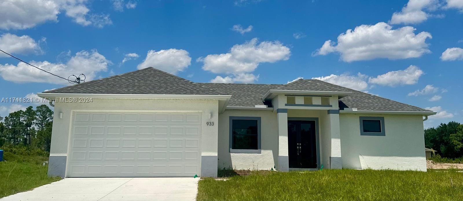 a front view of a house with a yard