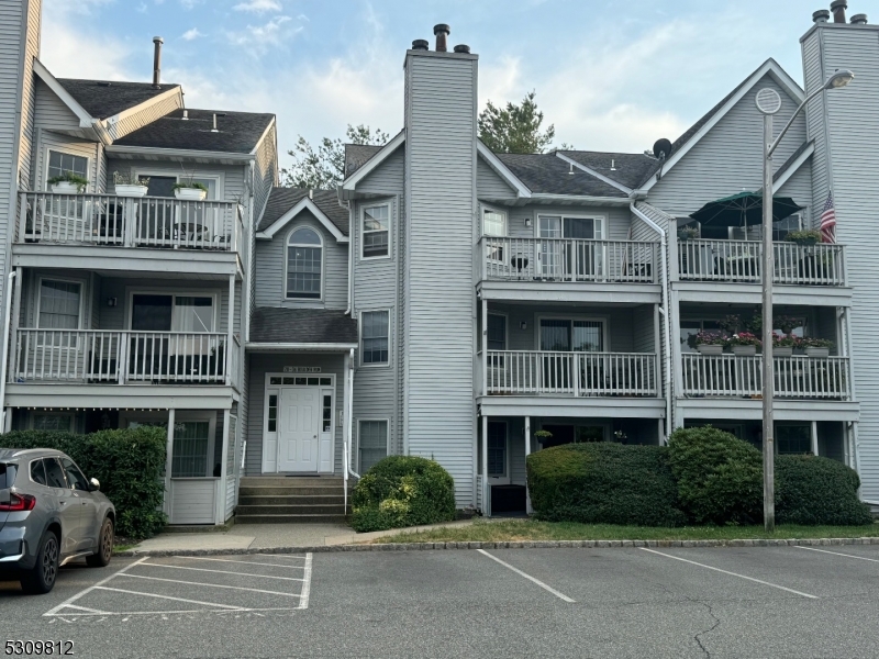 a front view of a residential apartment building with a yard