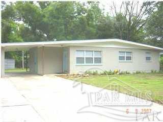 a view of a house with a backyard and a tree