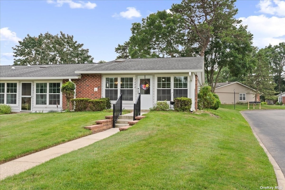 a view of a house with a backyard and a patio