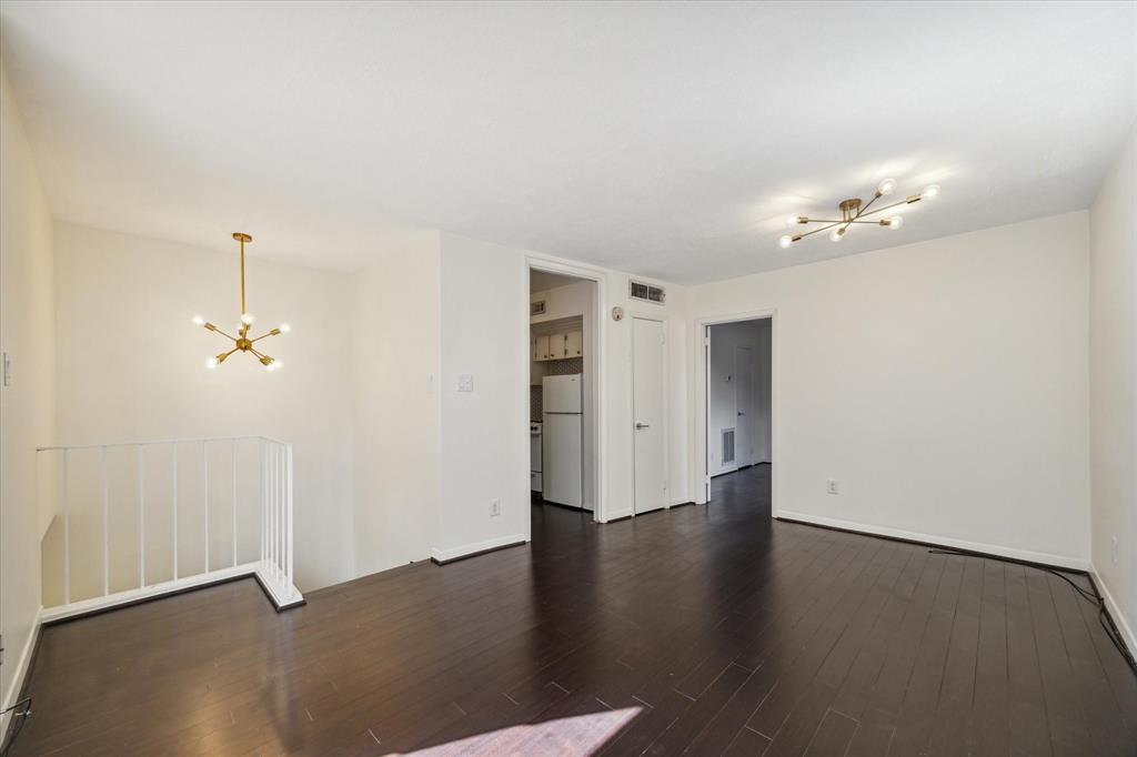 an empty room with wooden floor and window