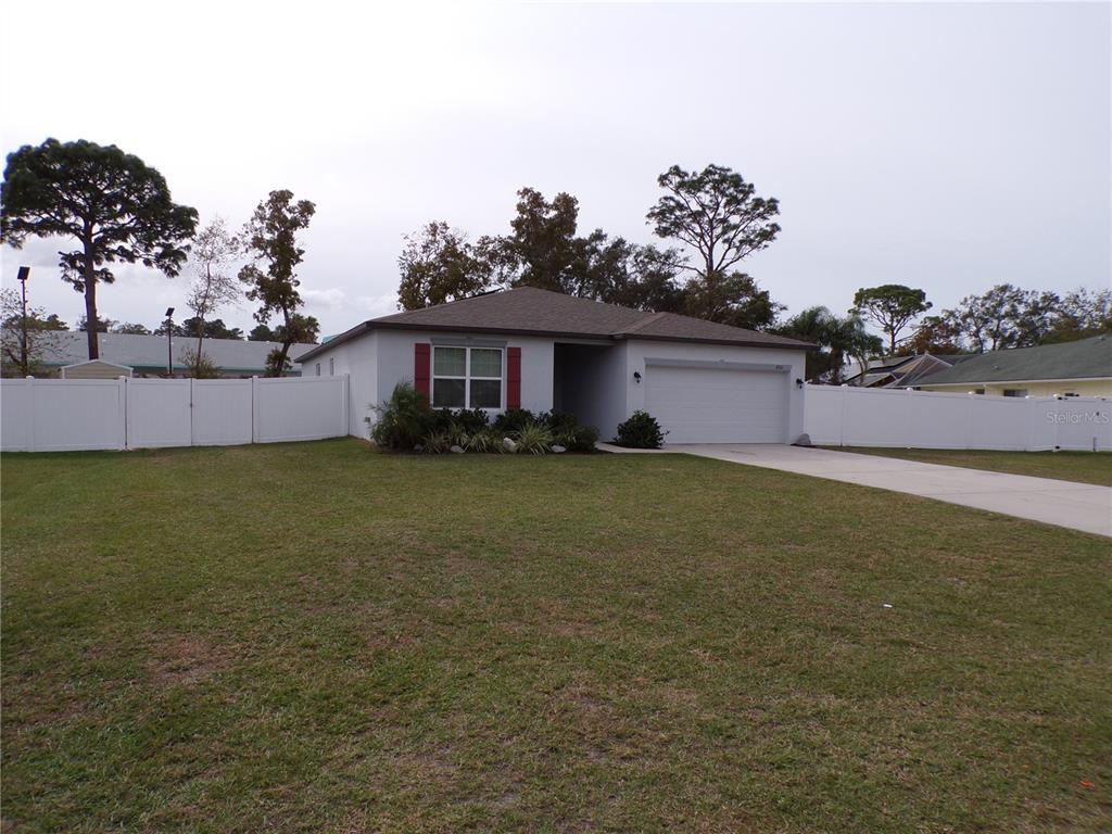 a front view of a house with a garden and yard