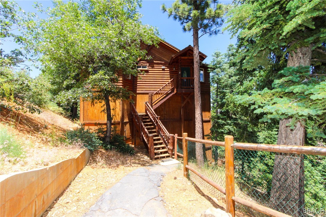 a view of balcony with wooden floor and fence