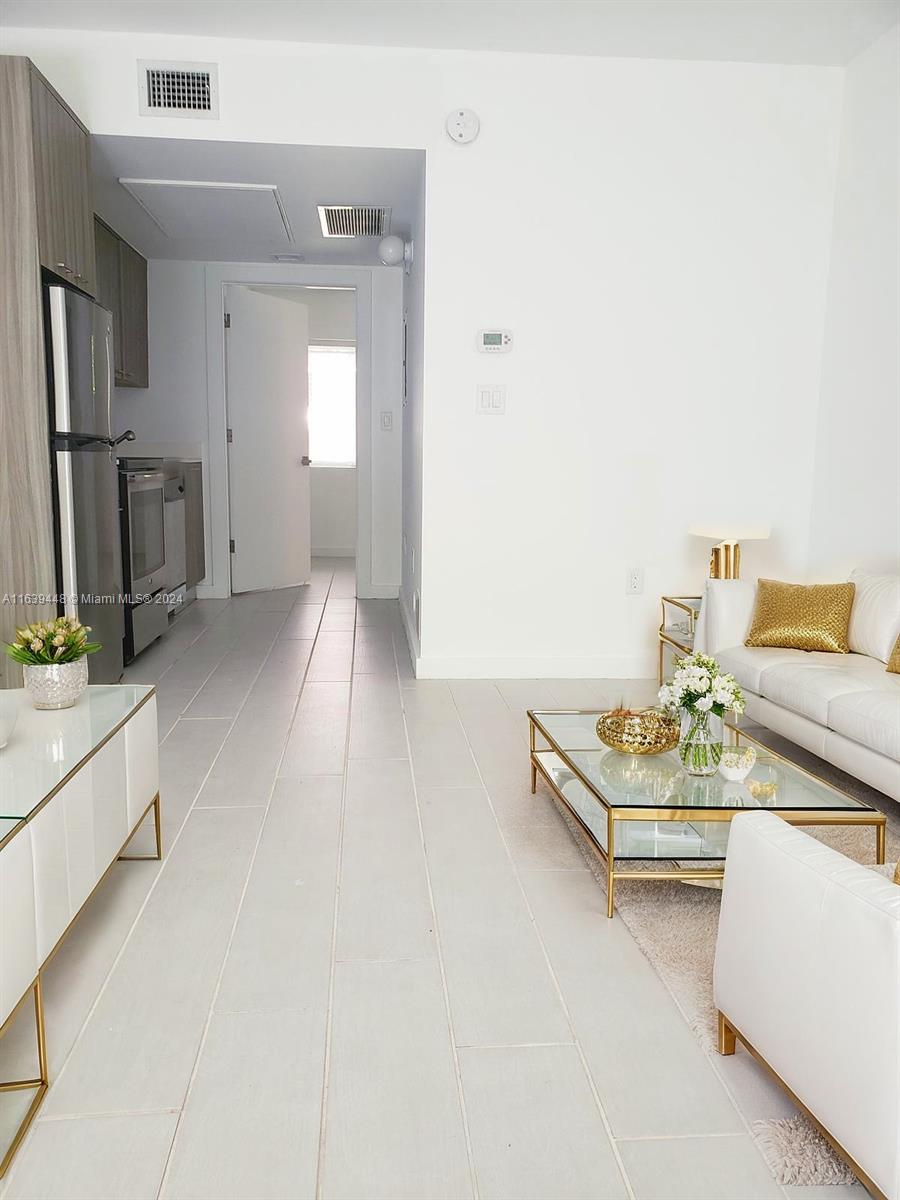 a living room with furniture and flat screen tv