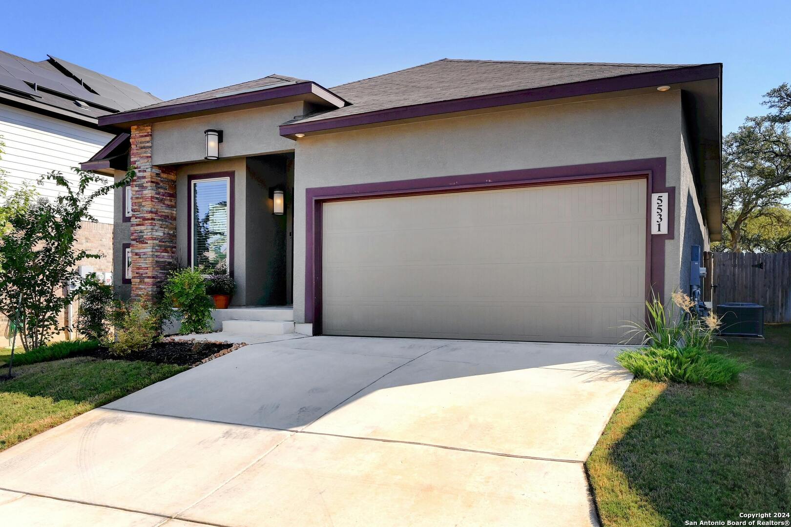 a front view of a house with garden