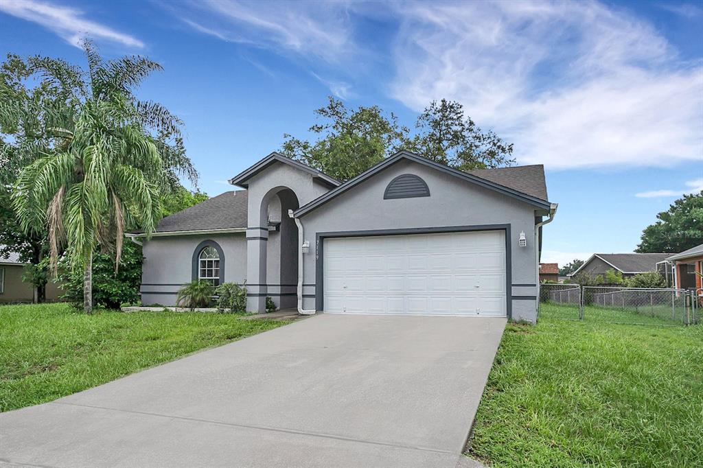 a front view of a house with a yard and garage