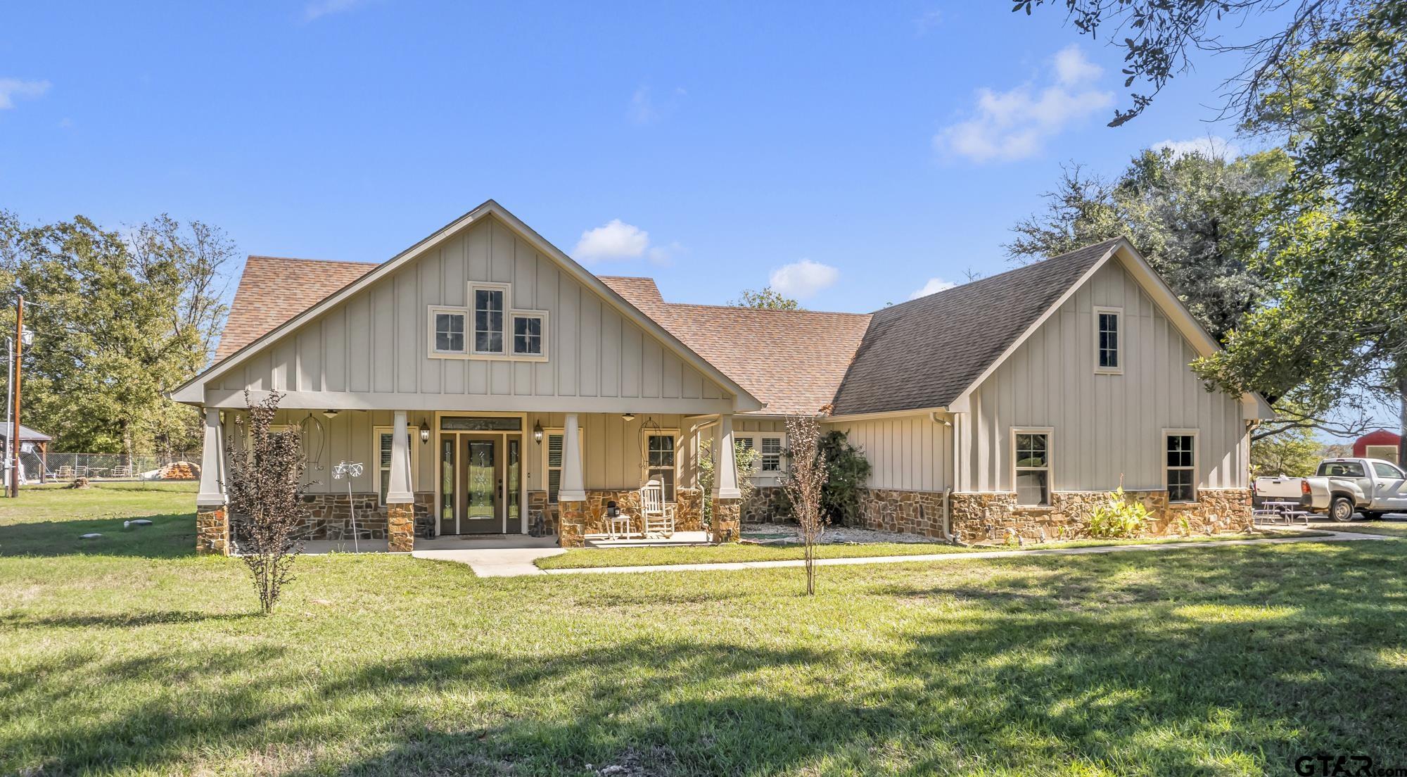 a front view of house with yard and green space