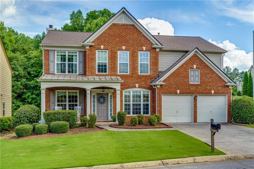 front view of brick house with a yard