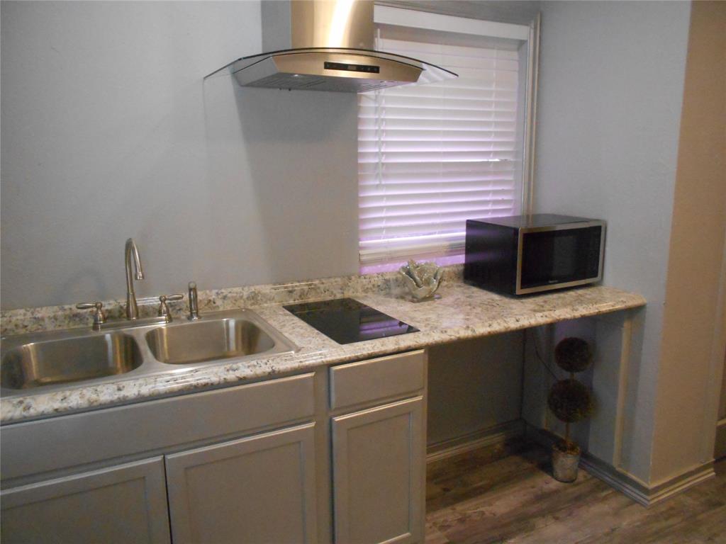 a kitchen with a sink and a microwave