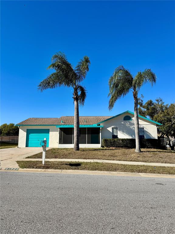 a view of a house with palm trees