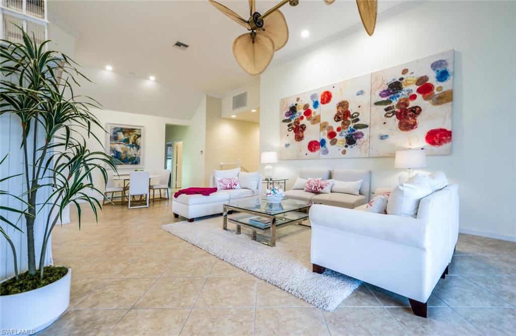 a living room with furniture and potted plant