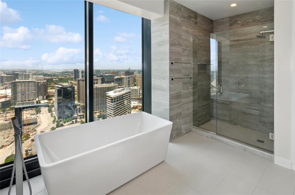 a white bath tub sitting under a bathroom