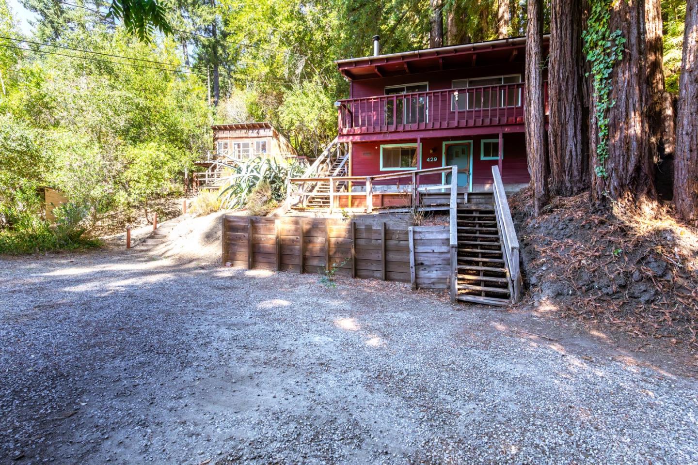 a view of a house with a yard and wooden fence