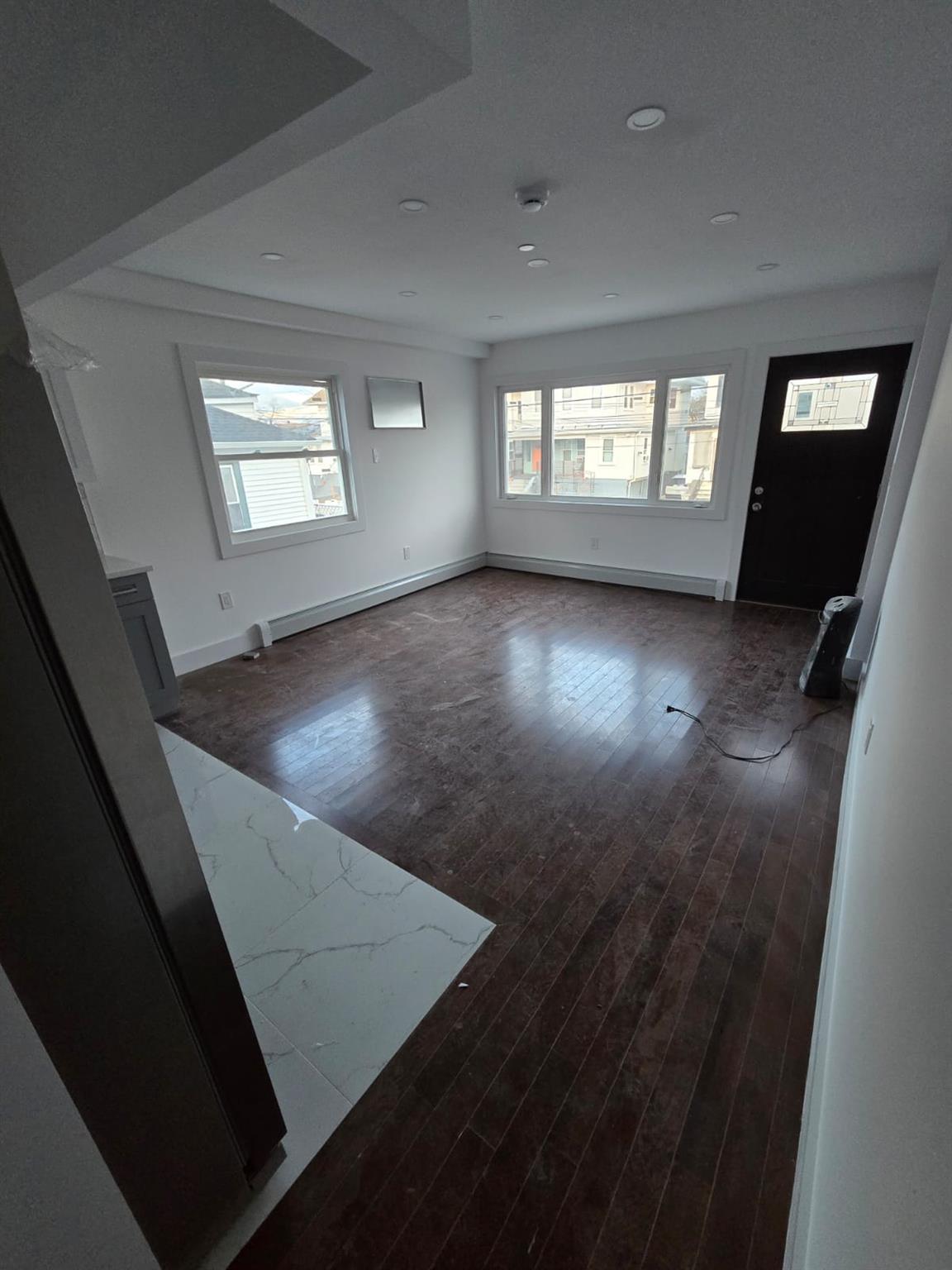 Foyer featuring dark hardwood / wood-style flooring and a baseboard radiator