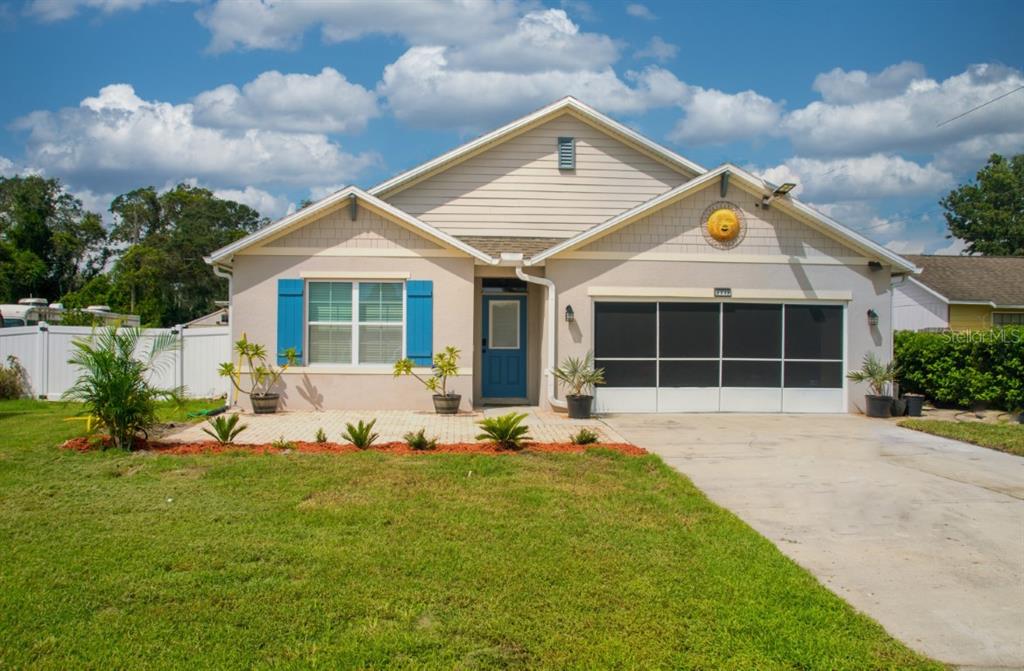 a front view of a house with a garden and yard