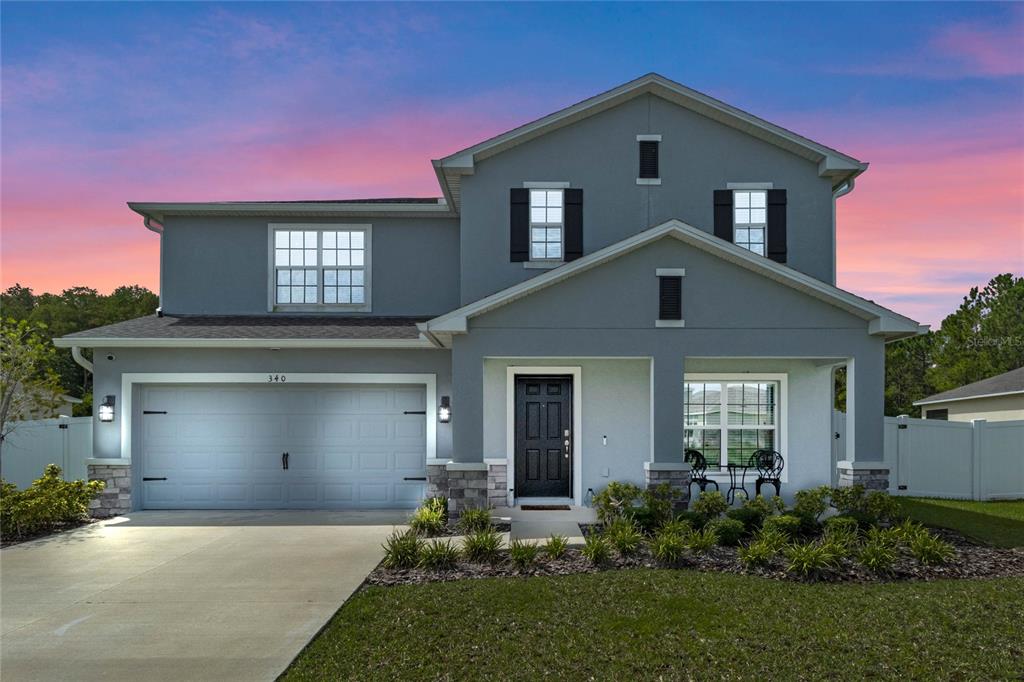 a front view of a house with a yard and garage