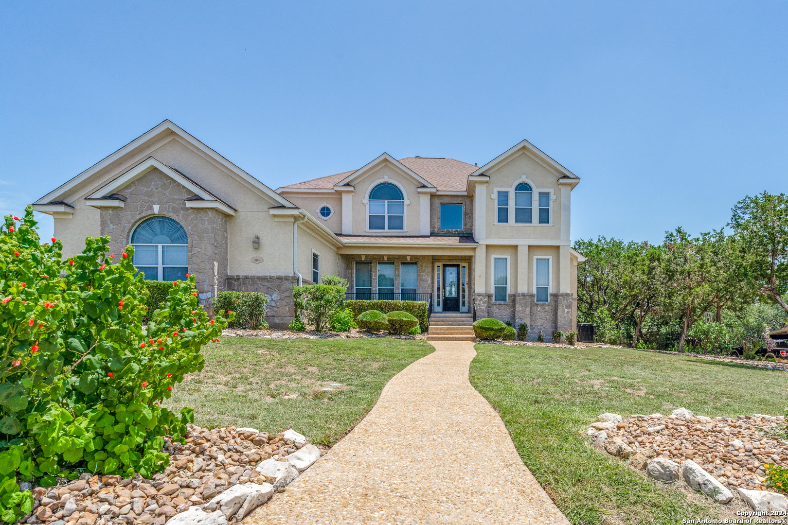 a front view of a house with a yard