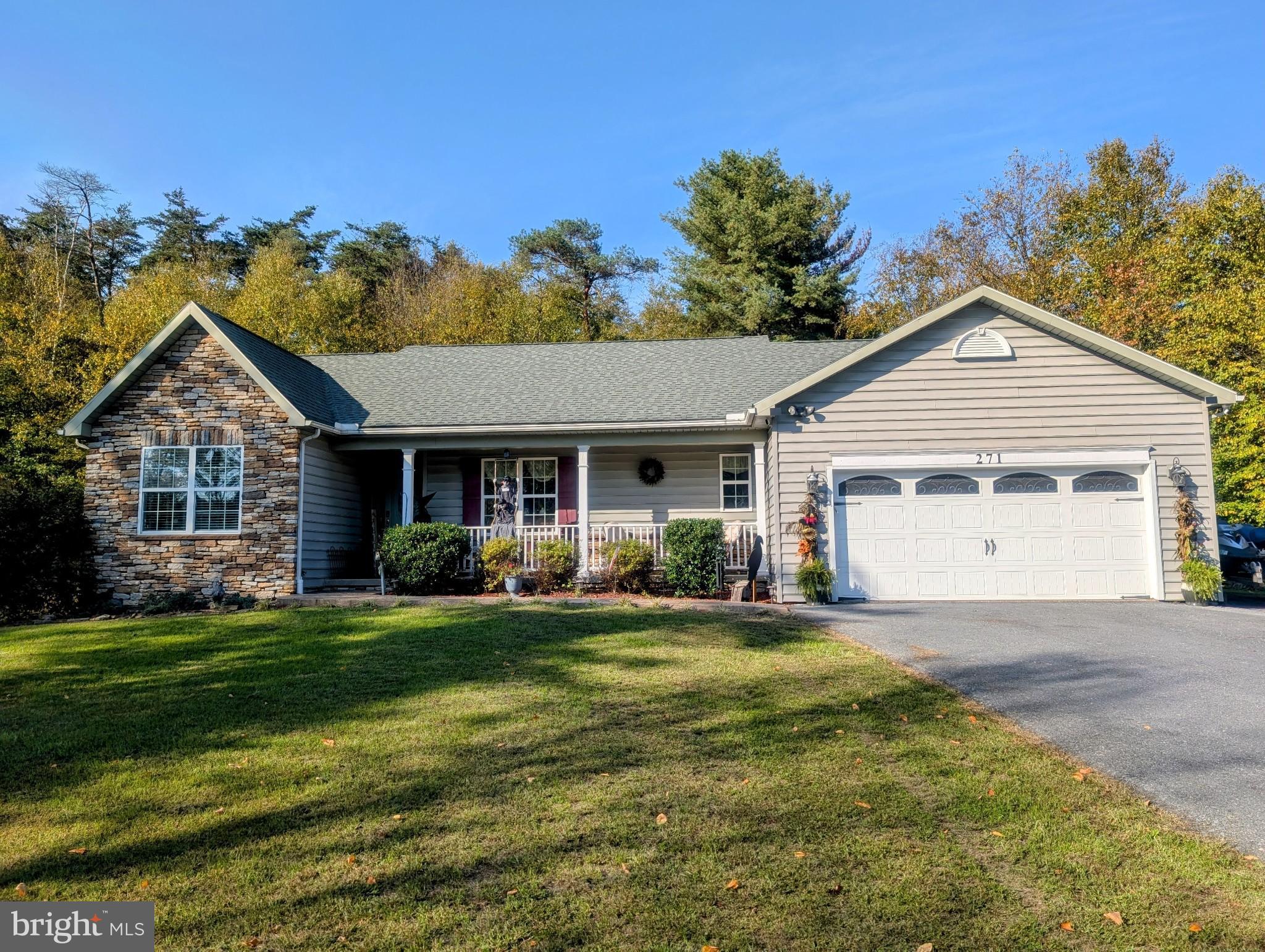 a front view of a house with a garden and yard