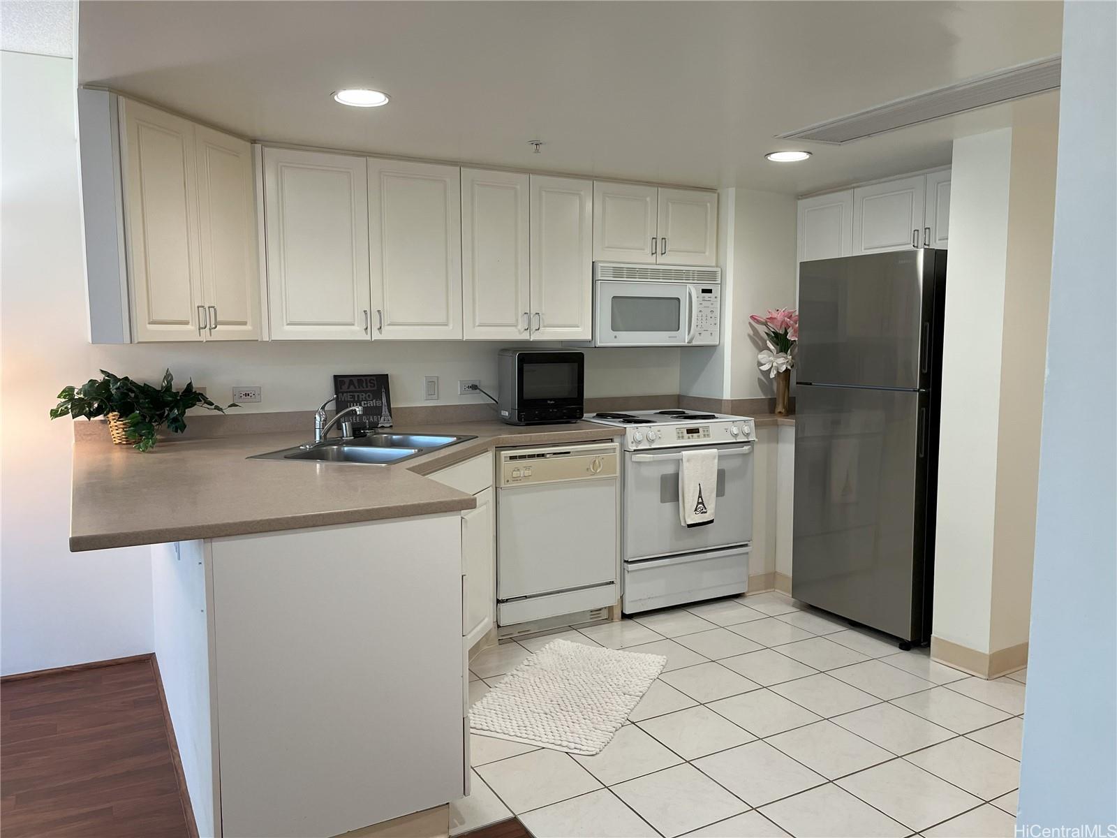 a kitchen with white cabinets and white stainless steel appliances