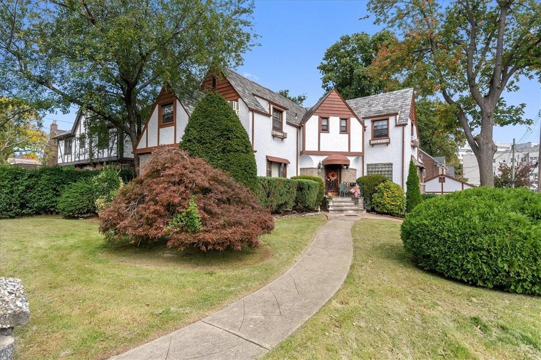 Tudor house featuring a front lawn