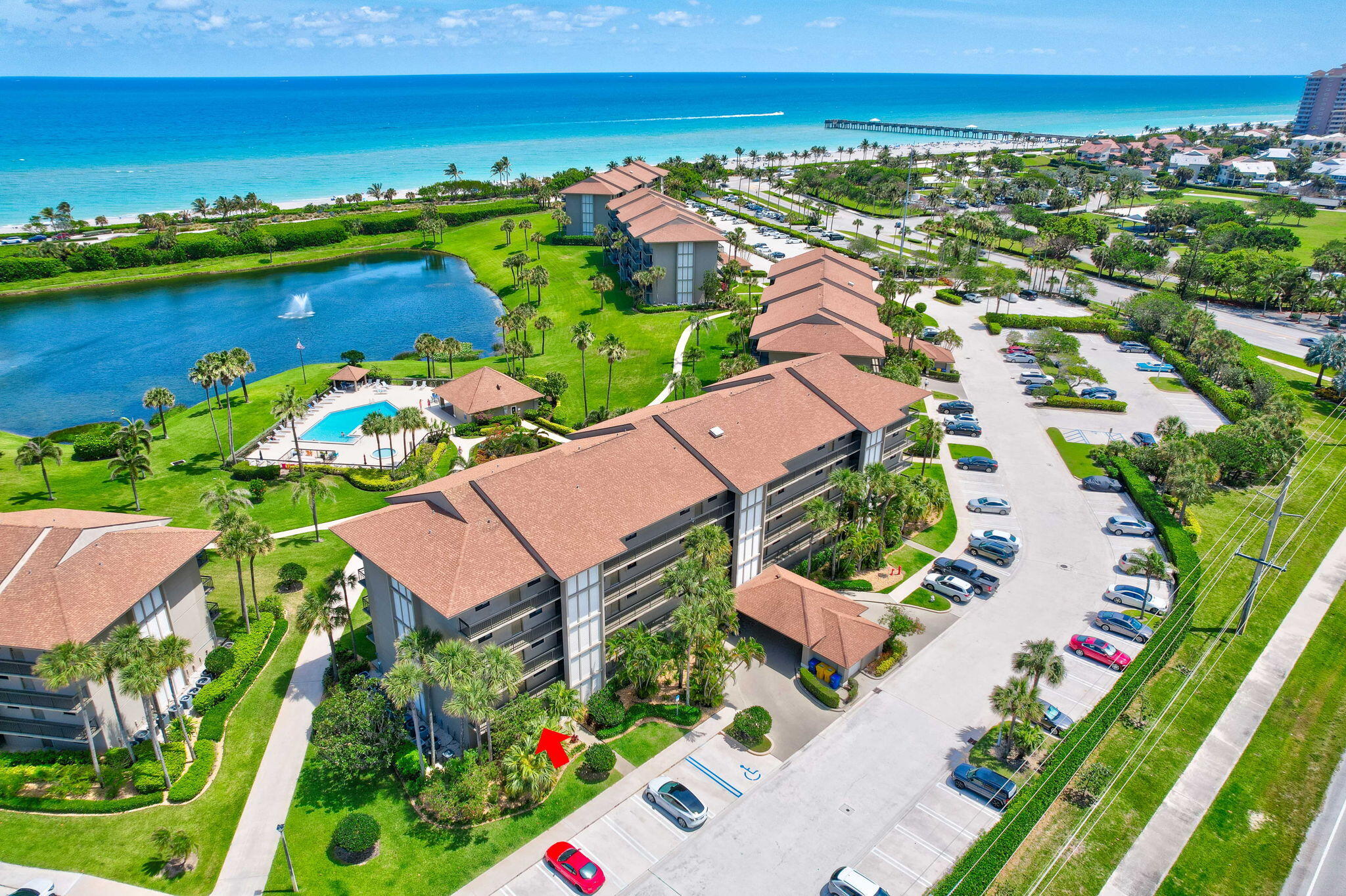 an aerial view of residential houses with outdoor space and lake view