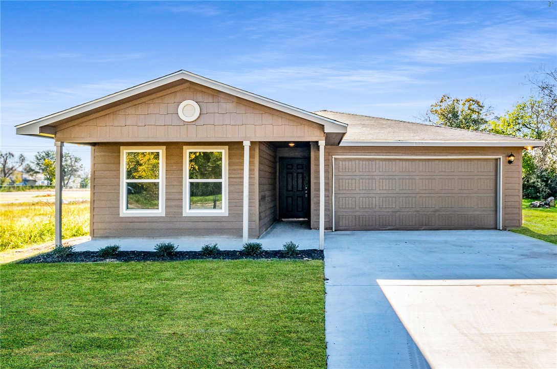 a front view of house with yard and outdoor seating