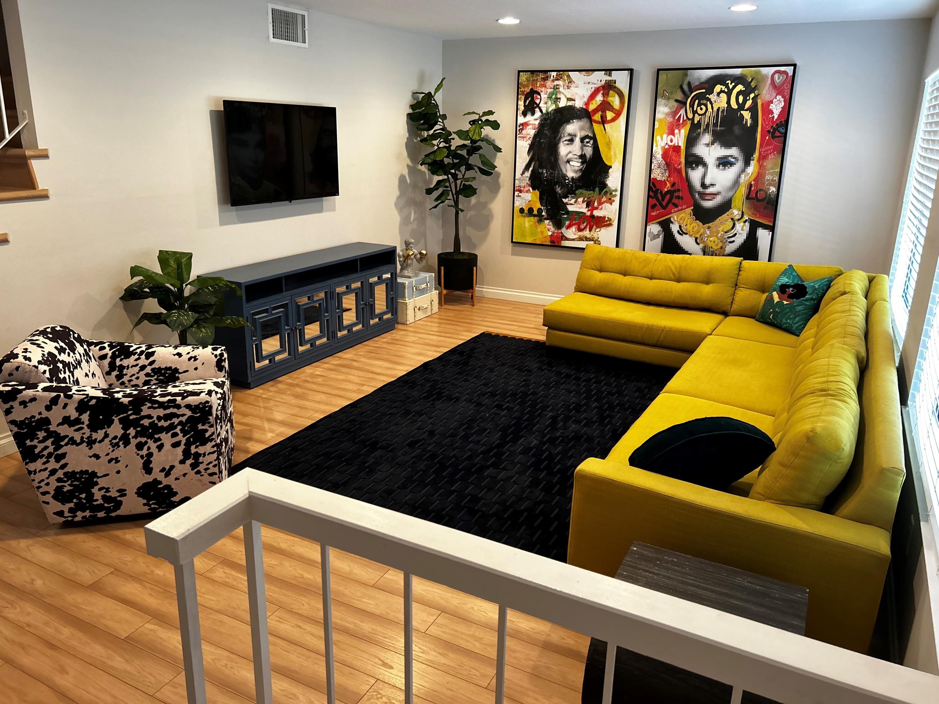 a living room with furniture and a flat screen tv