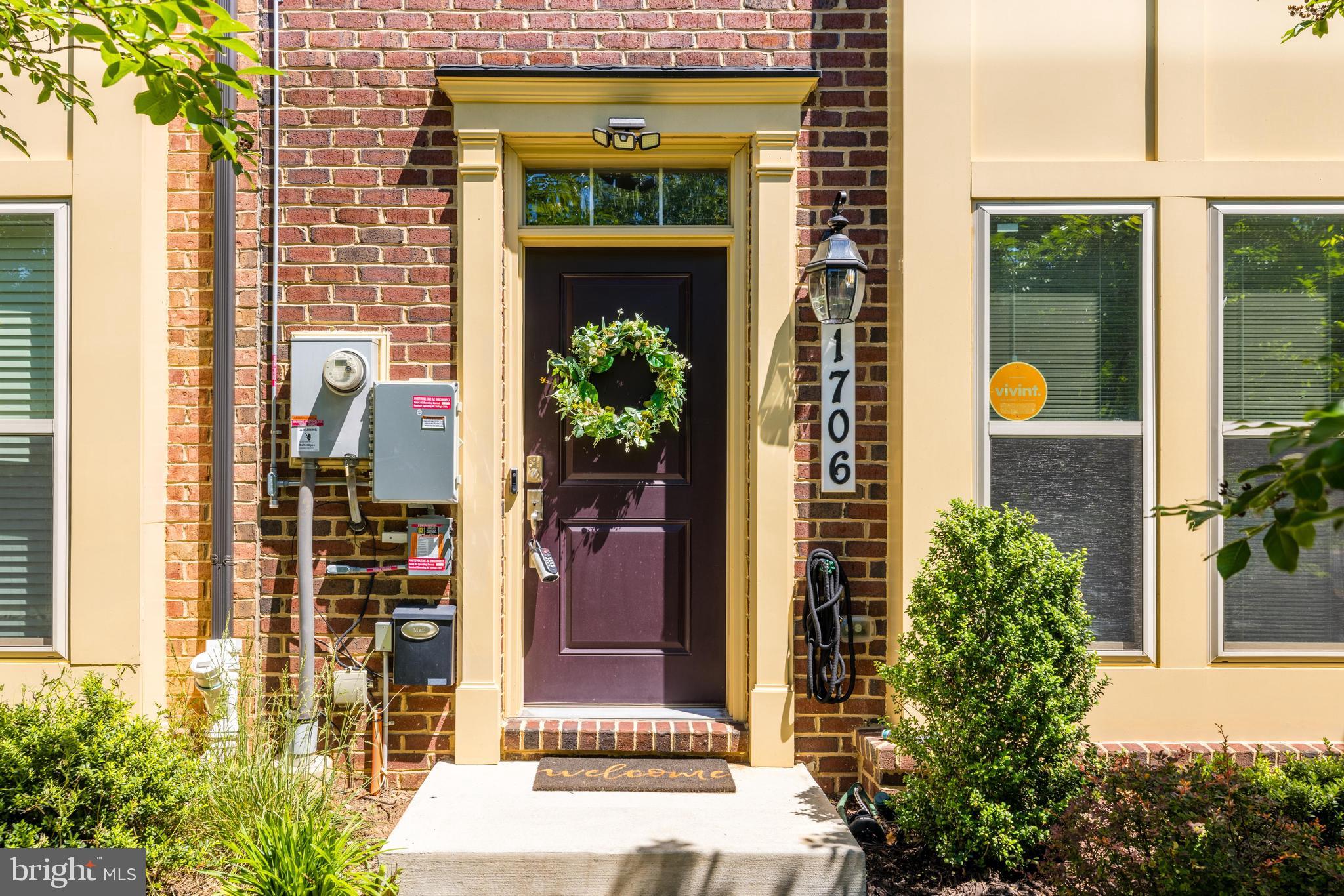 a front view of a house with a plants