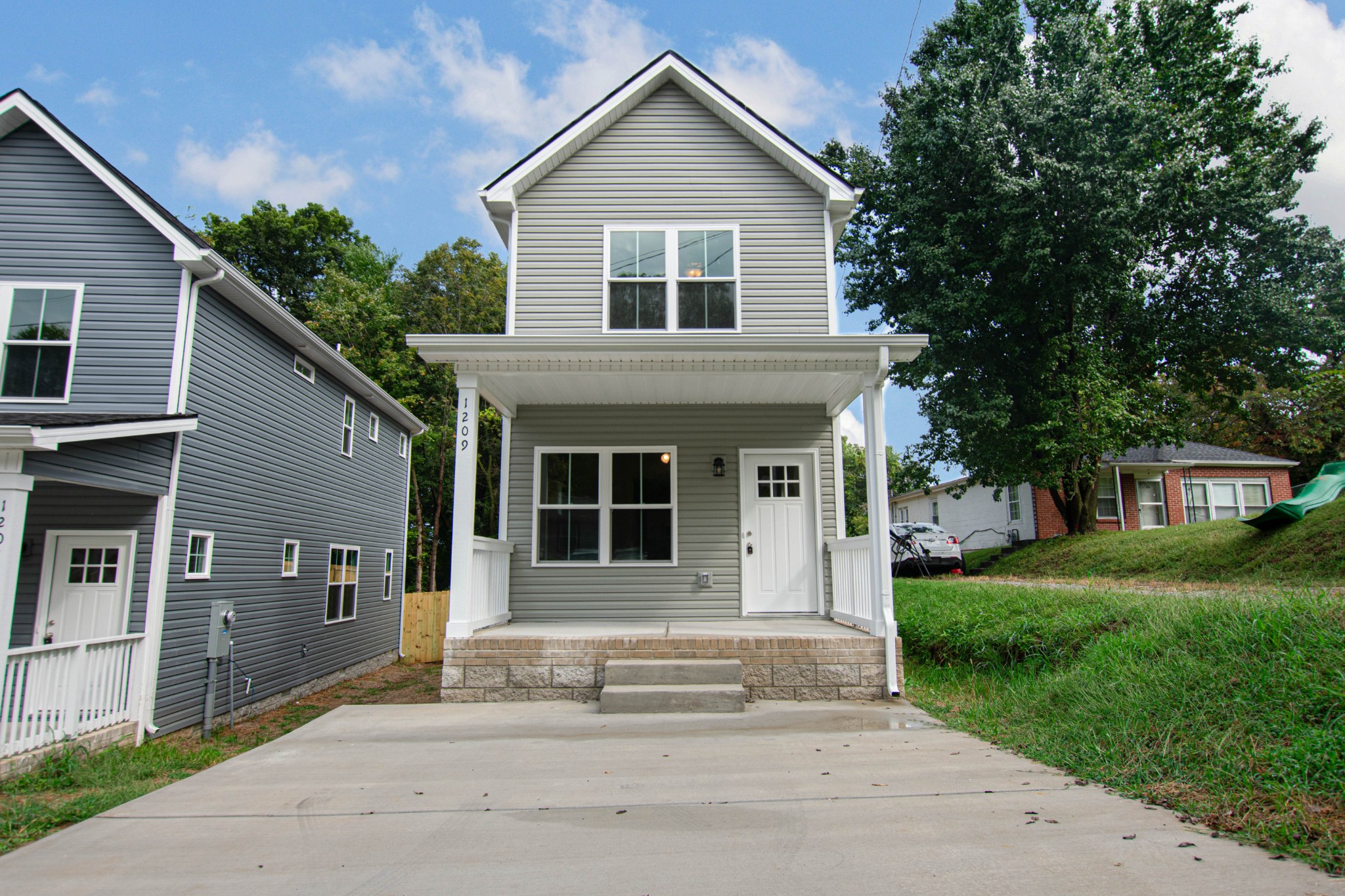 a front view of a house with a garden