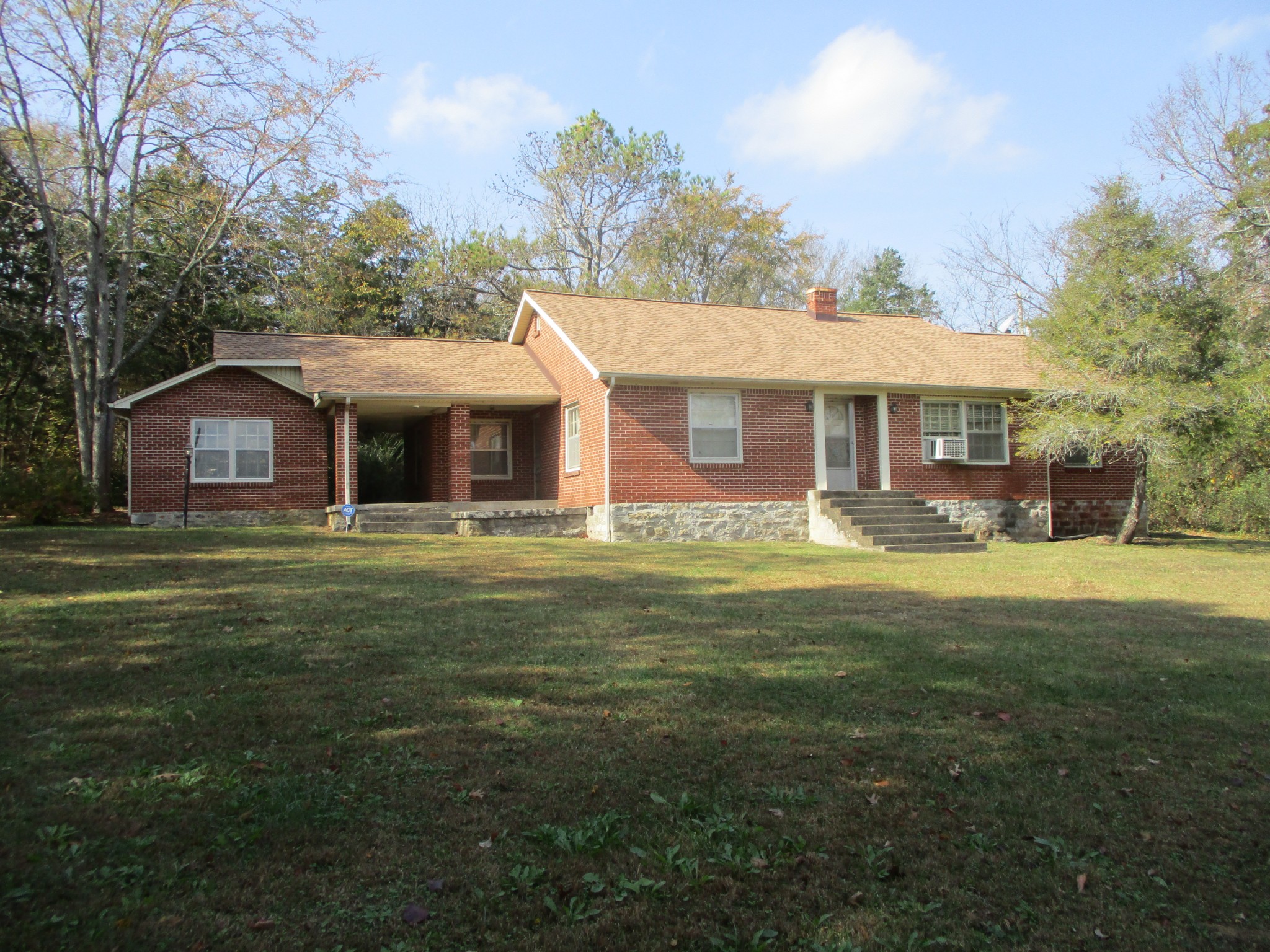 a front view of house with yard outdoor seating and green space