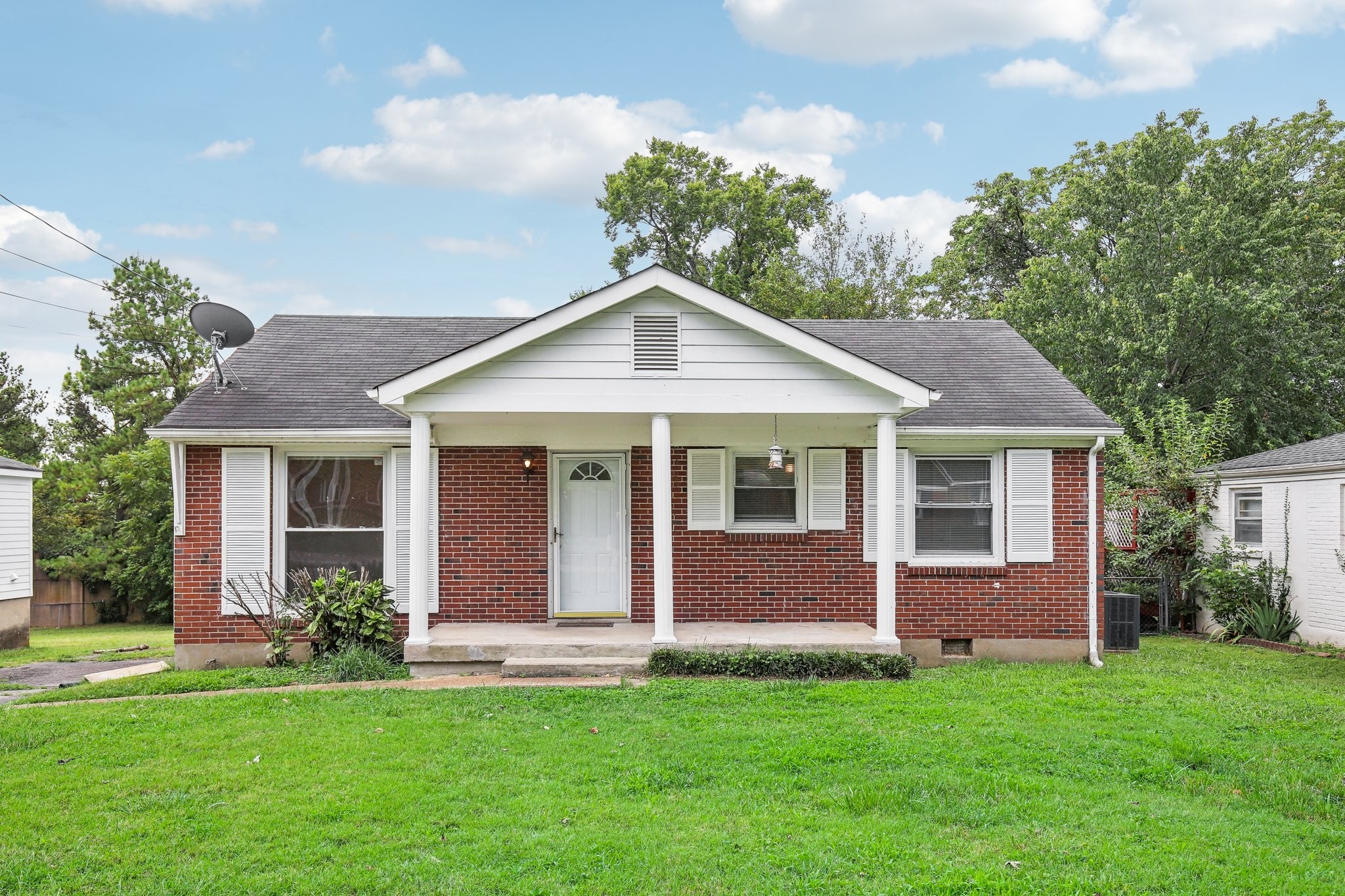 a front view of a house with a garden