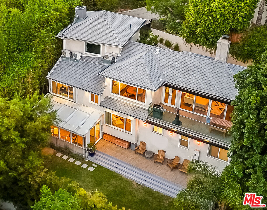 an aerial view of multiple houses with yard