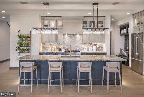 a kitchen with kitchen island granite countertop a table and chairs in it