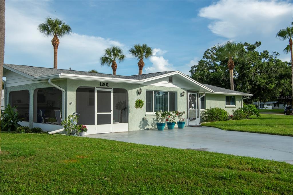 a front view of a house with garden and porch