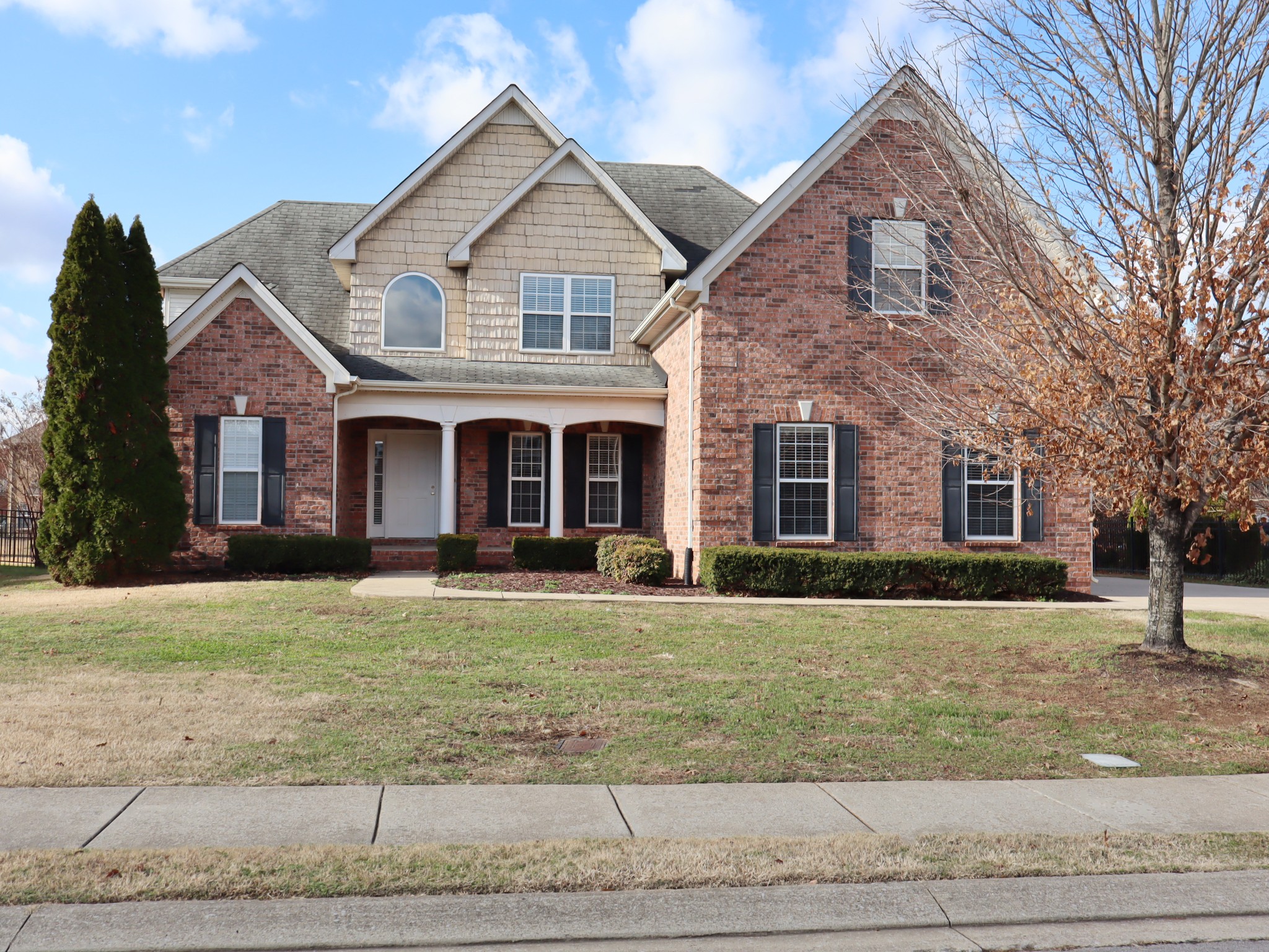 a front view of a house with a yard