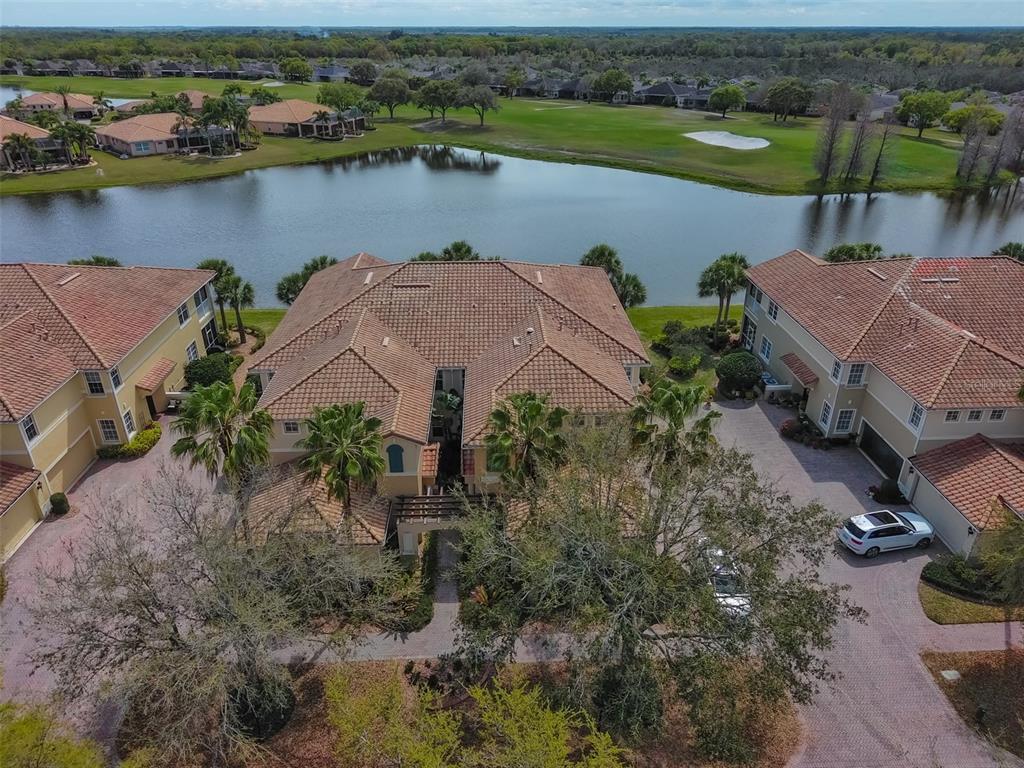 Exquisite Mediterranean style, luxury upstairs condo unit right on the water with a view of the Renaissance Golf Course.