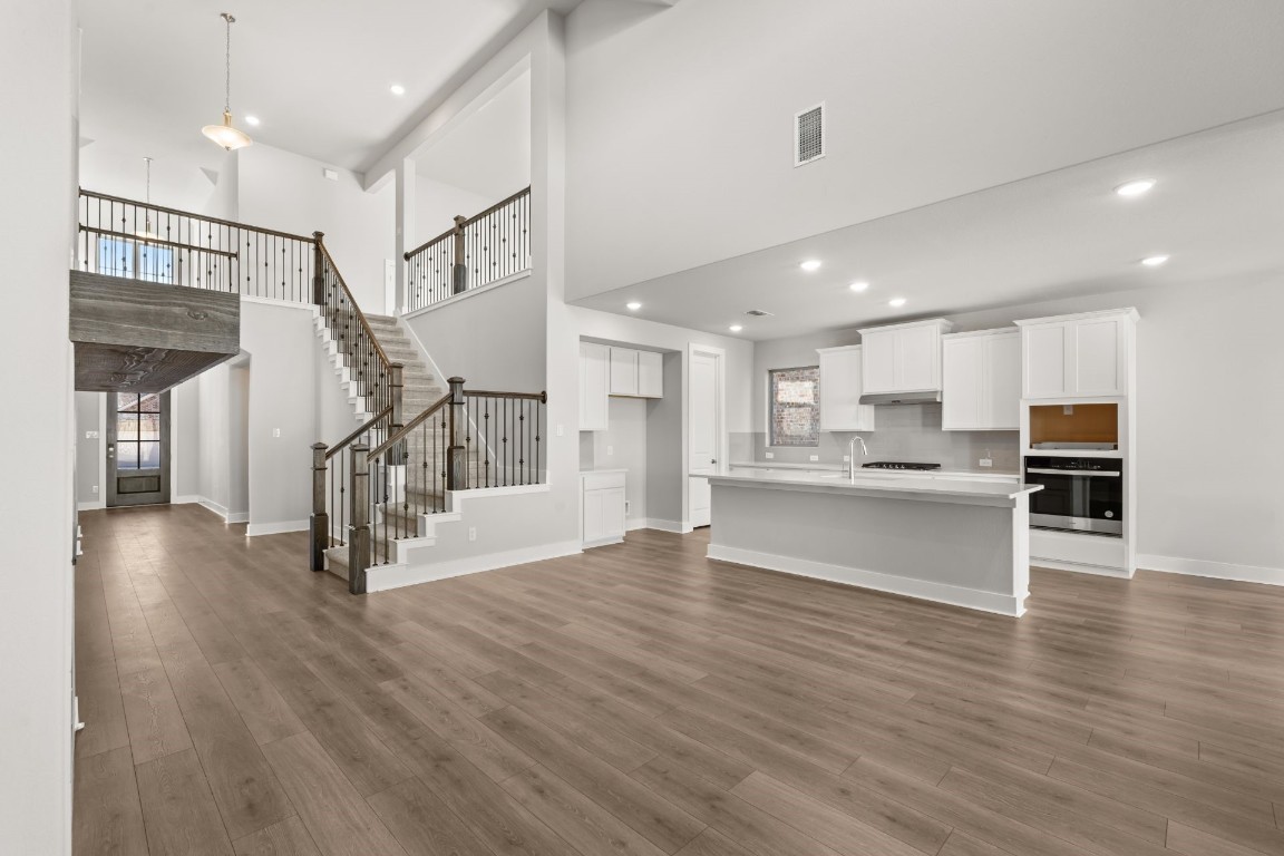 a view of kitchen with cabinets and wooden floor