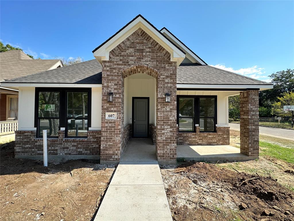 a front view of a house with glass windows and yard