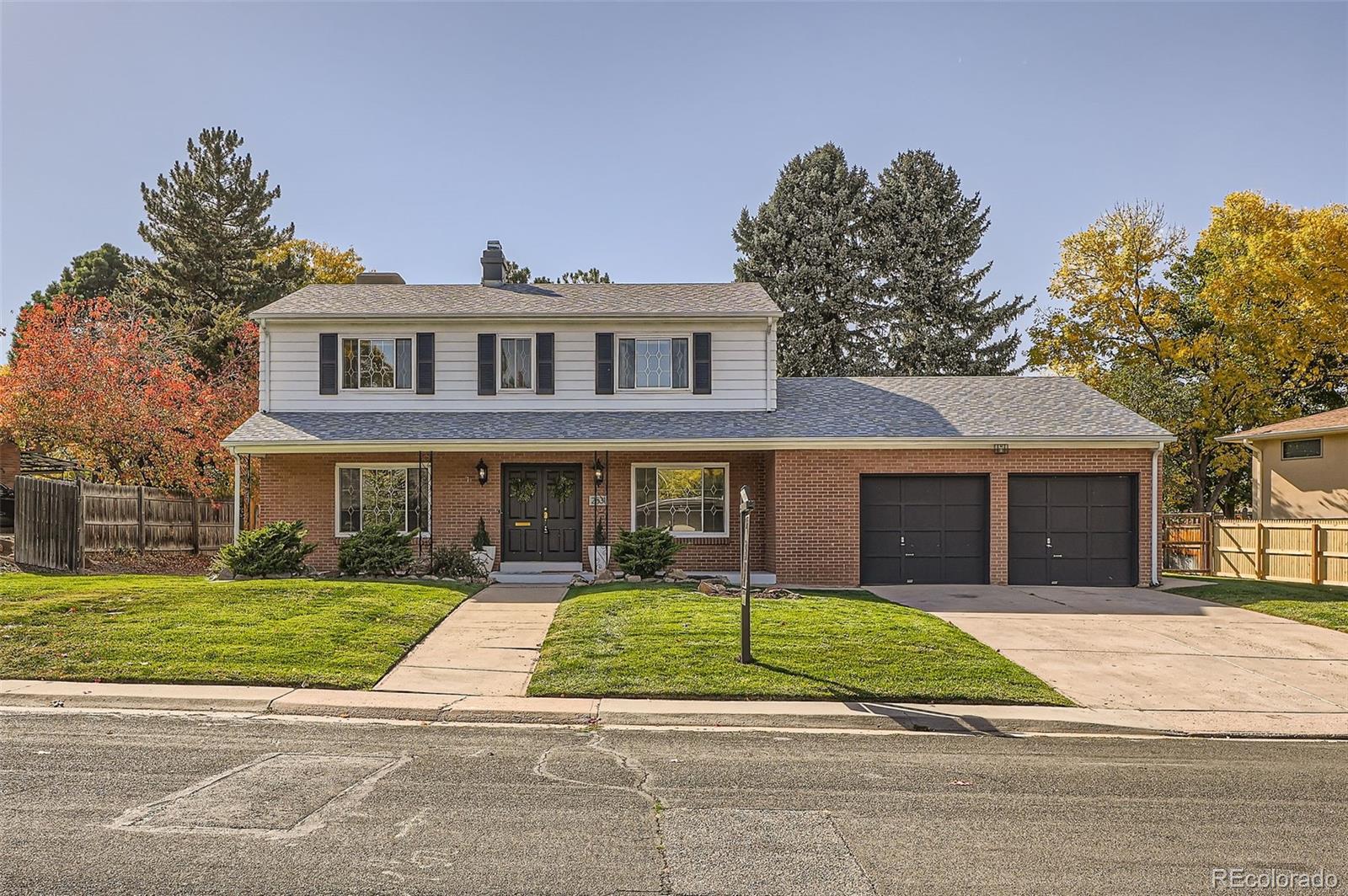 a front view of a house with a garden and plants