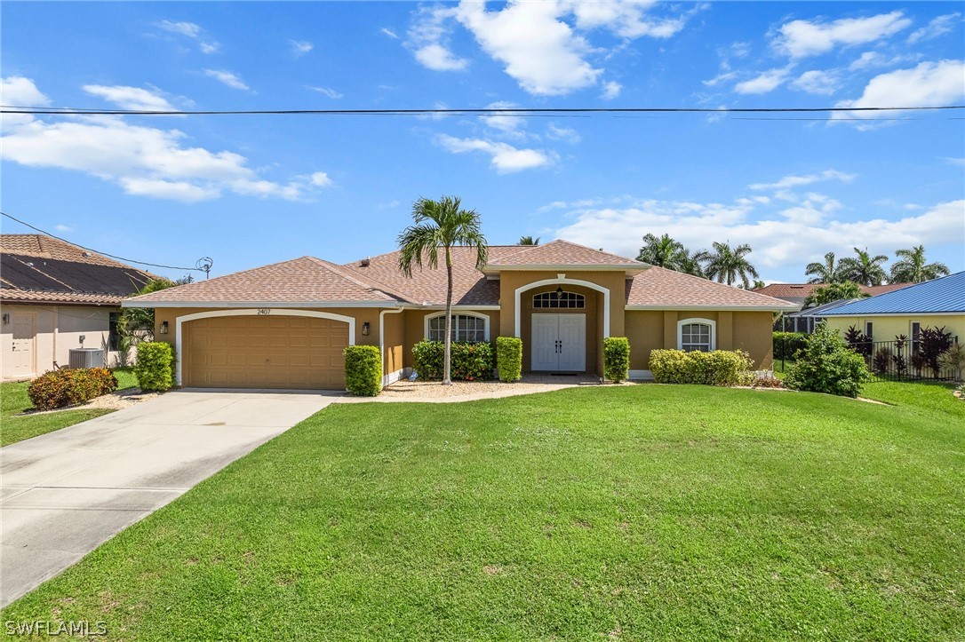 a front view of a house with a garden and yard