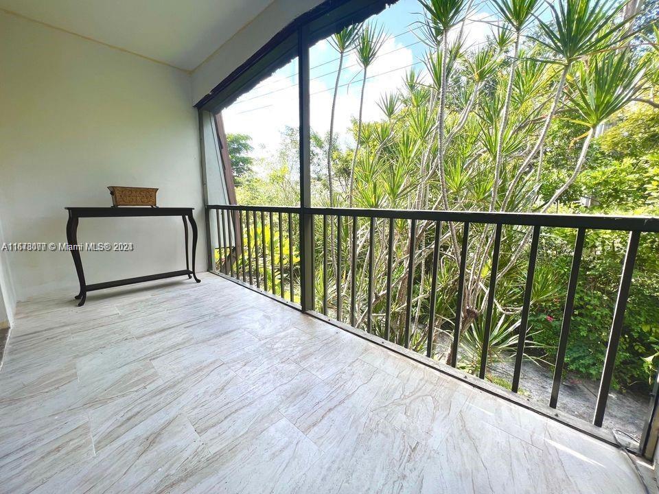 a view of a balcony with furniture