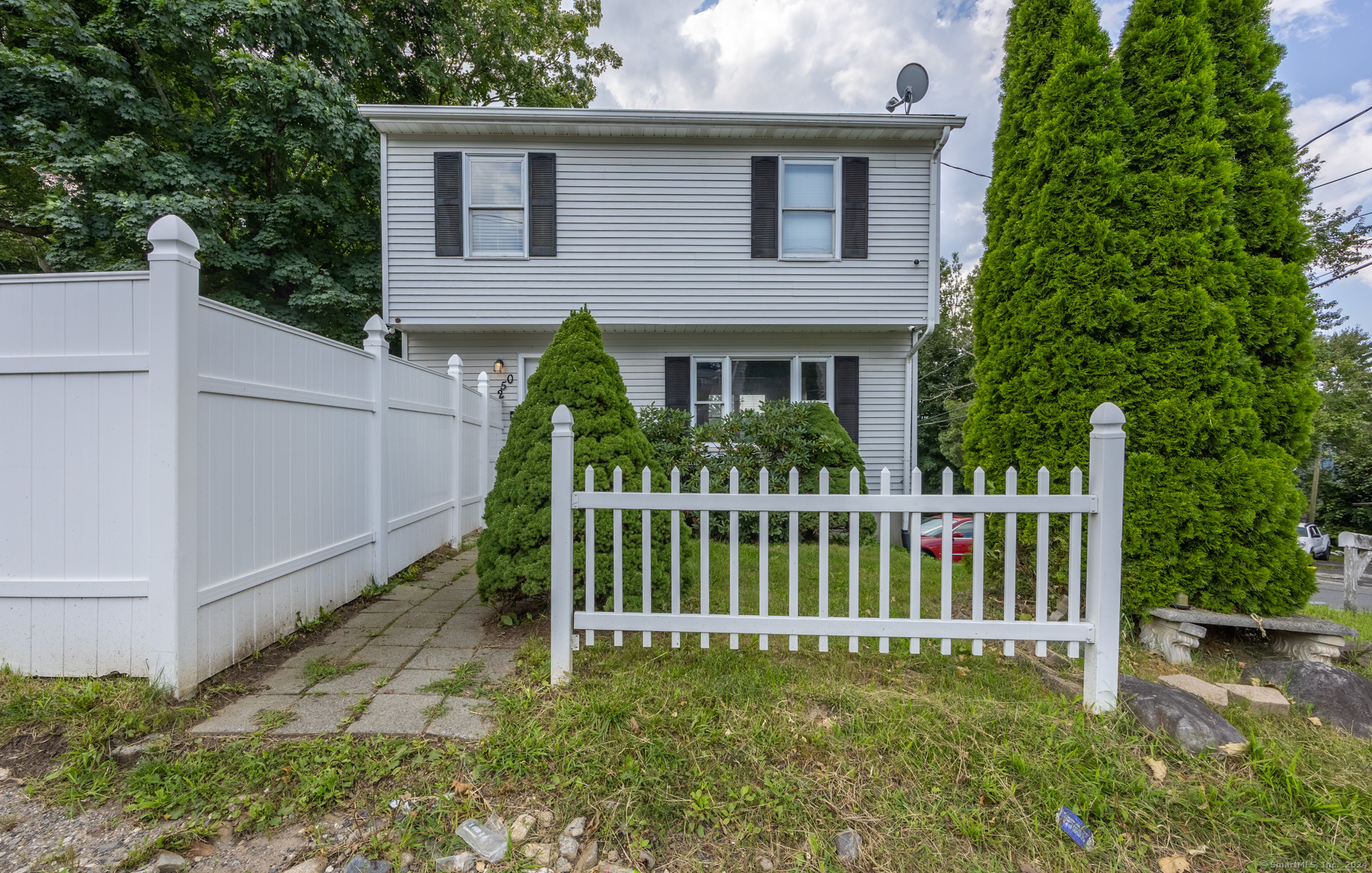 a view of a house with a small yard and plants